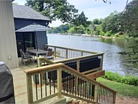 <b>Waterfront Pressure Treated Wood Deck with Wood Railing and Black Aluminum Balusters</b>